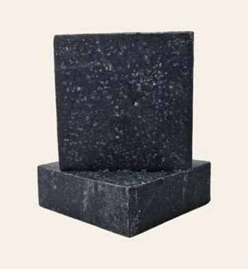 Aryabhoomi Naturals charcoal soap with green leaf on a white background